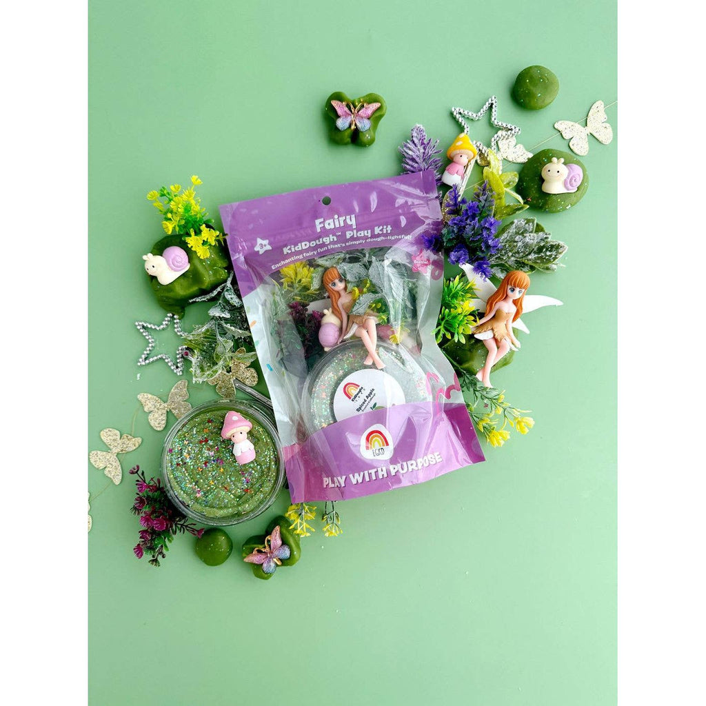 Fairy play kit with figurines and accessories on a green background