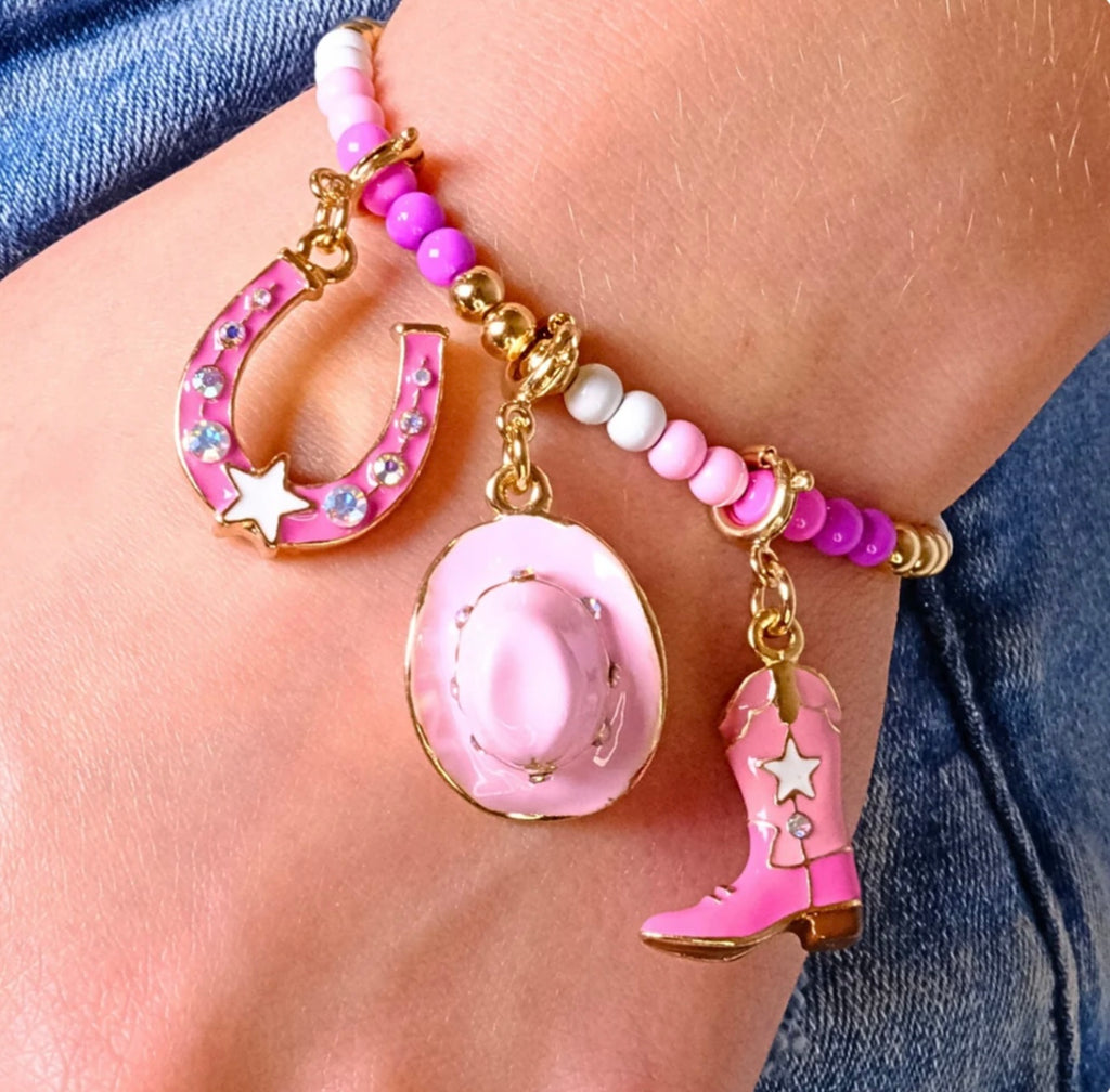 Pink cowboy boot charm with gold accents on a white background