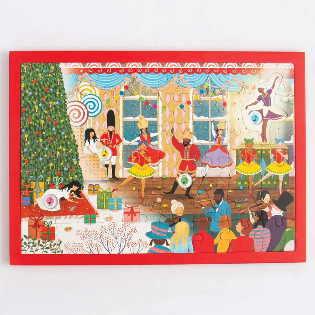 The Nutcracker Musical Puzzle box by The Nutcracker Orchestra, shown with several wooden puzzle pieces scattered in front on a clean white background.