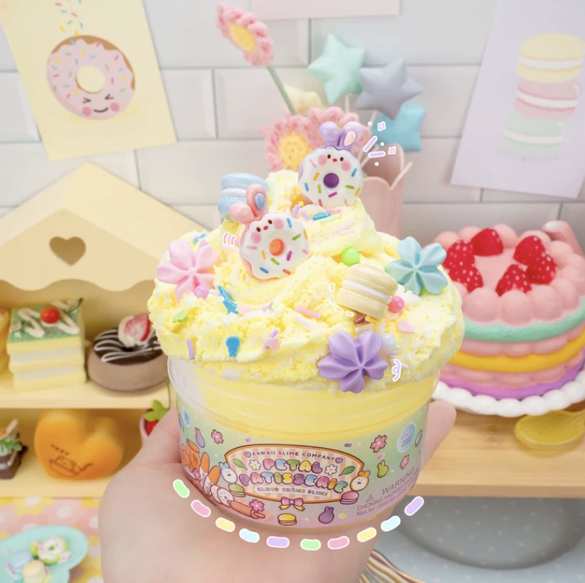 Toy set in a decorative container with a pink bow on a white background