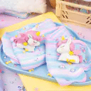 Unicorn-themed product in a clear container with colorful packaging on a white background