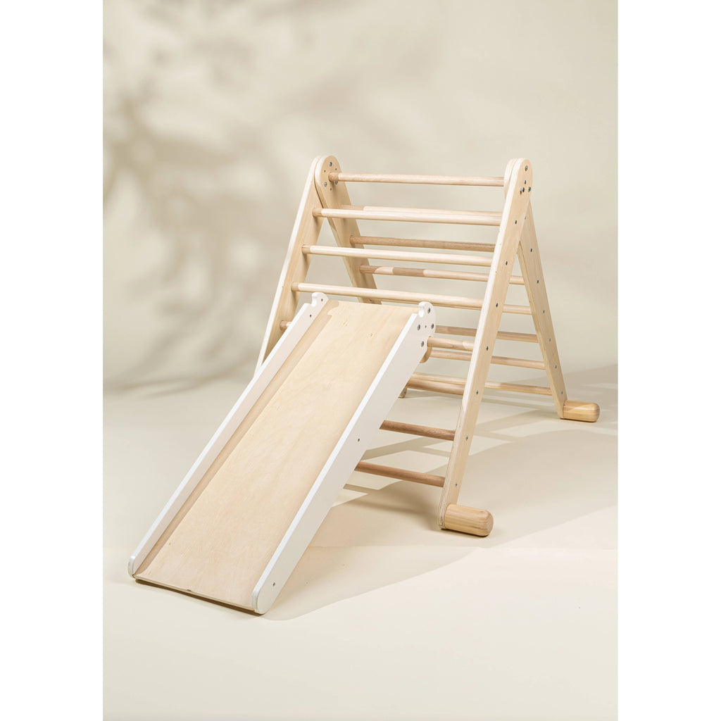 Wooden climbing toy with a slide and rocks on a beige background