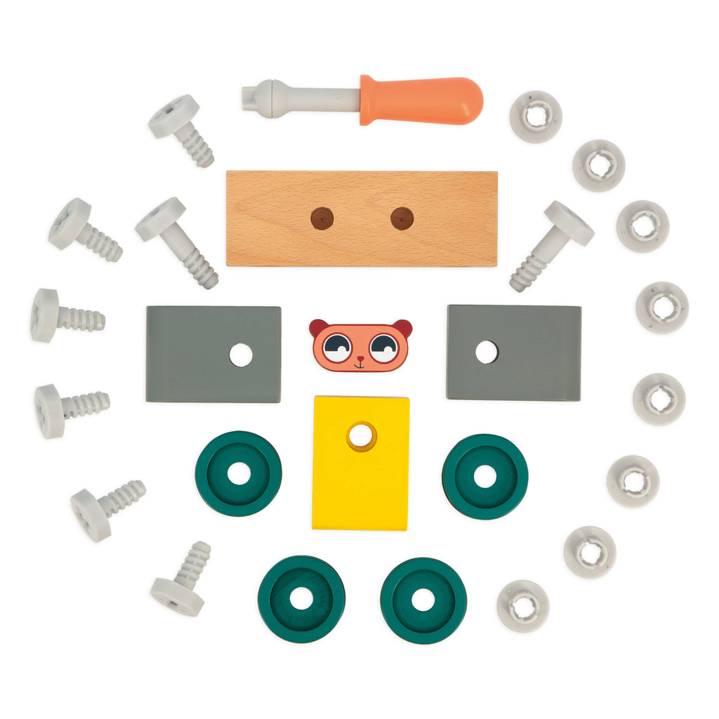 Janod wooden toy train set with a green, yellow, and pink train made of interlocking blocks, featuring green wheels and a separate orange and white screwdriver accessory, on a white background.