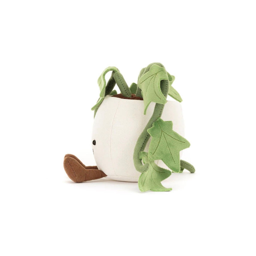 Plush toy of a white eggplant with green leaves on a white background