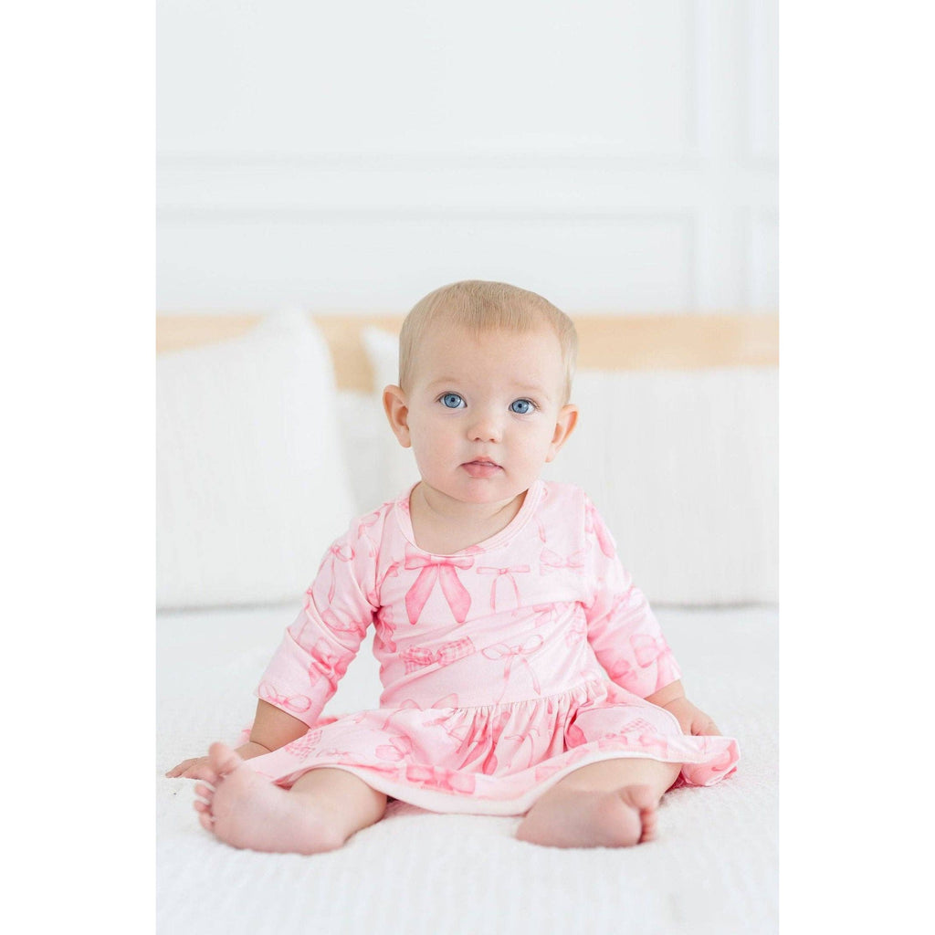 Pink dress with bow pattern on a white background