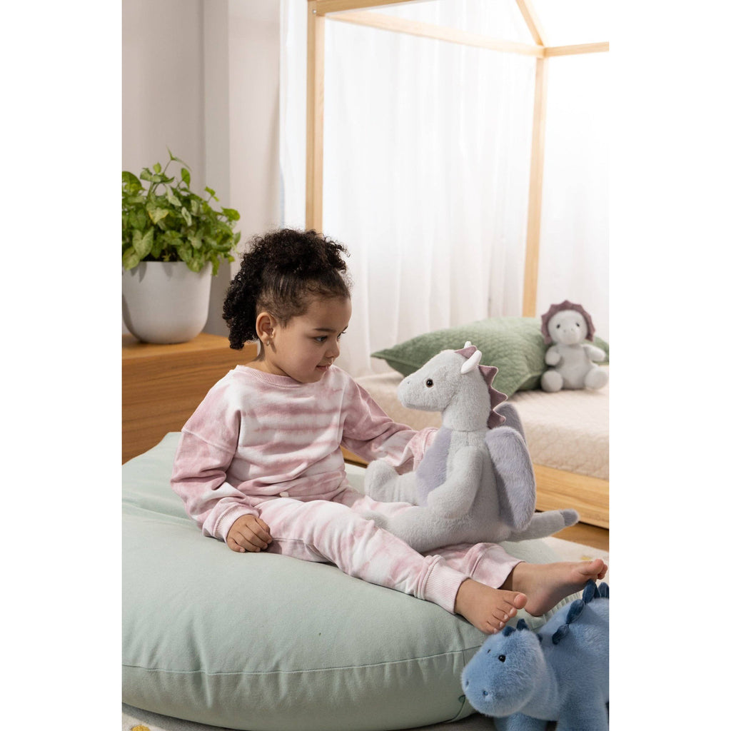 Plush dragon toy on a beige background