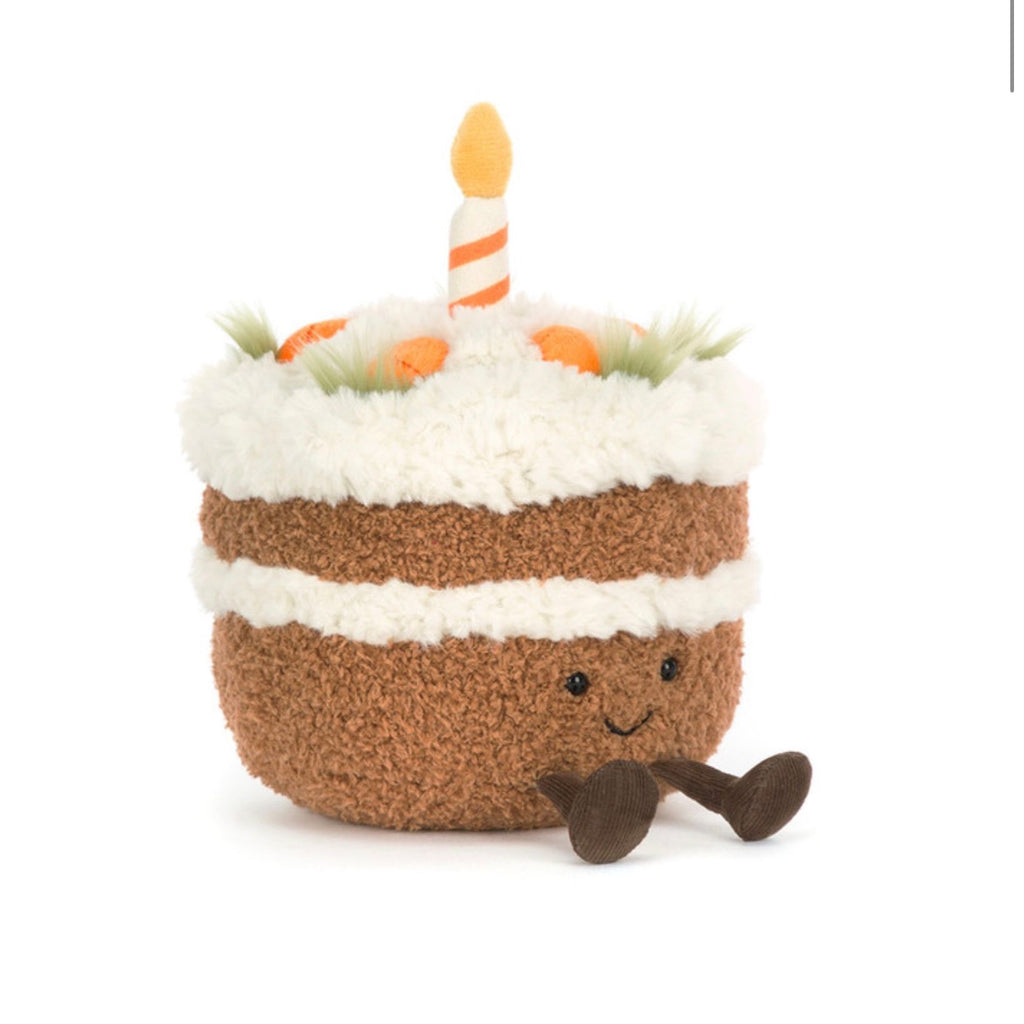 Toy cake with a candle on a white background