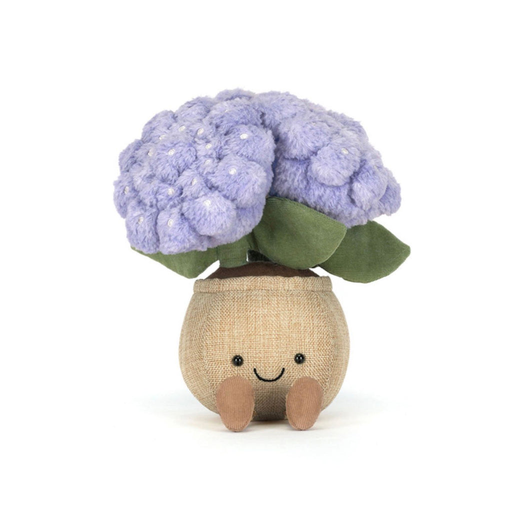Stuffed toy plant with purple flowers and a smiling face on a white background