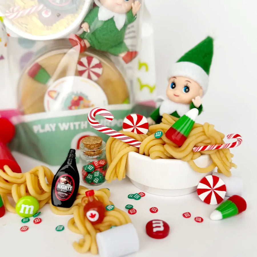 8 oz natural playdough, Elf Figurine, Noodle Shaped Dough Extruder, Candy Corns, Candy Canes, Swirly Mints, Candy Charm Mix-Ins, Maple and Chocolate Syrup Charms, Marshmallow Charms
