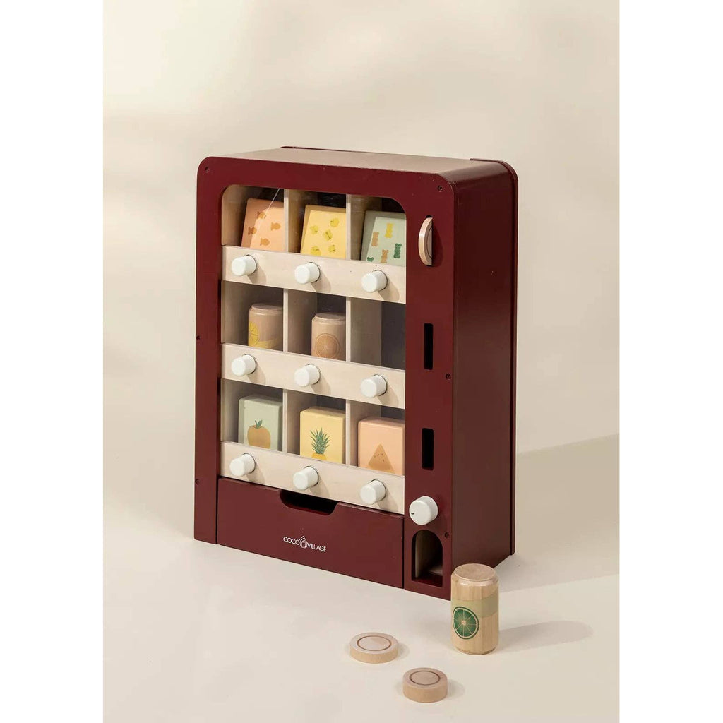 Wooden toy safe with compartments and small items on a beige background