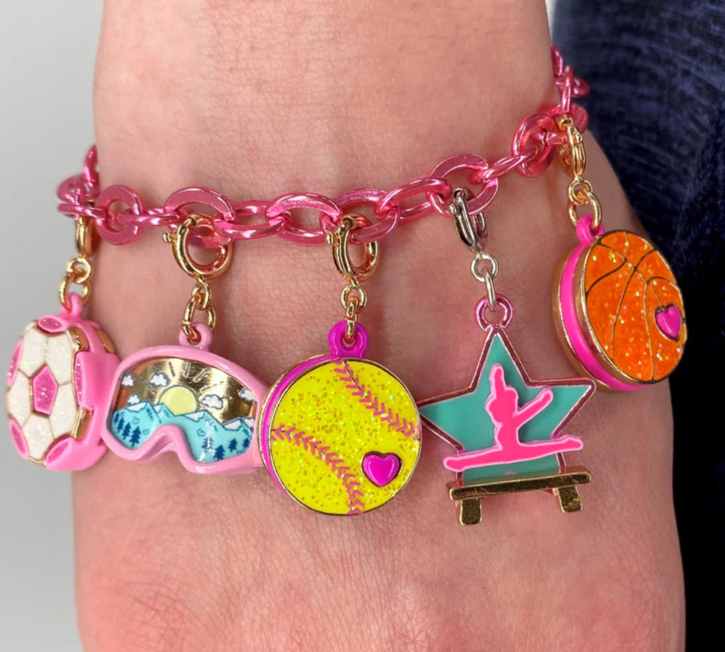 Charms for jewelry with a star design featuring a gymnast on a balance beam, on a white background.