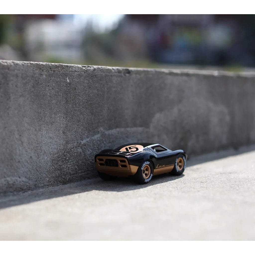 Model car with black and gold design on a white background