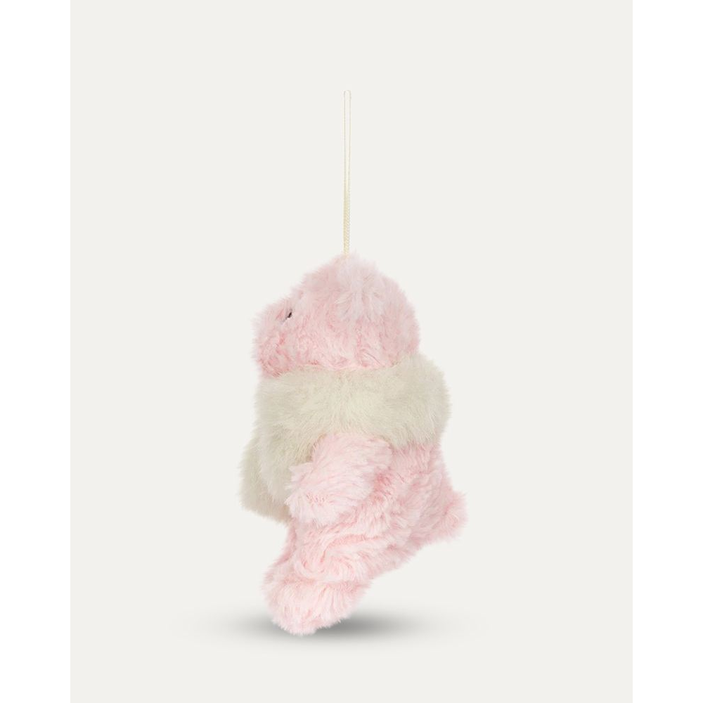 A small plush teddy bear hanging ornament in light pink and cream faux fur, with a cream ribbon loop at the top, shown against a plain off-white background.