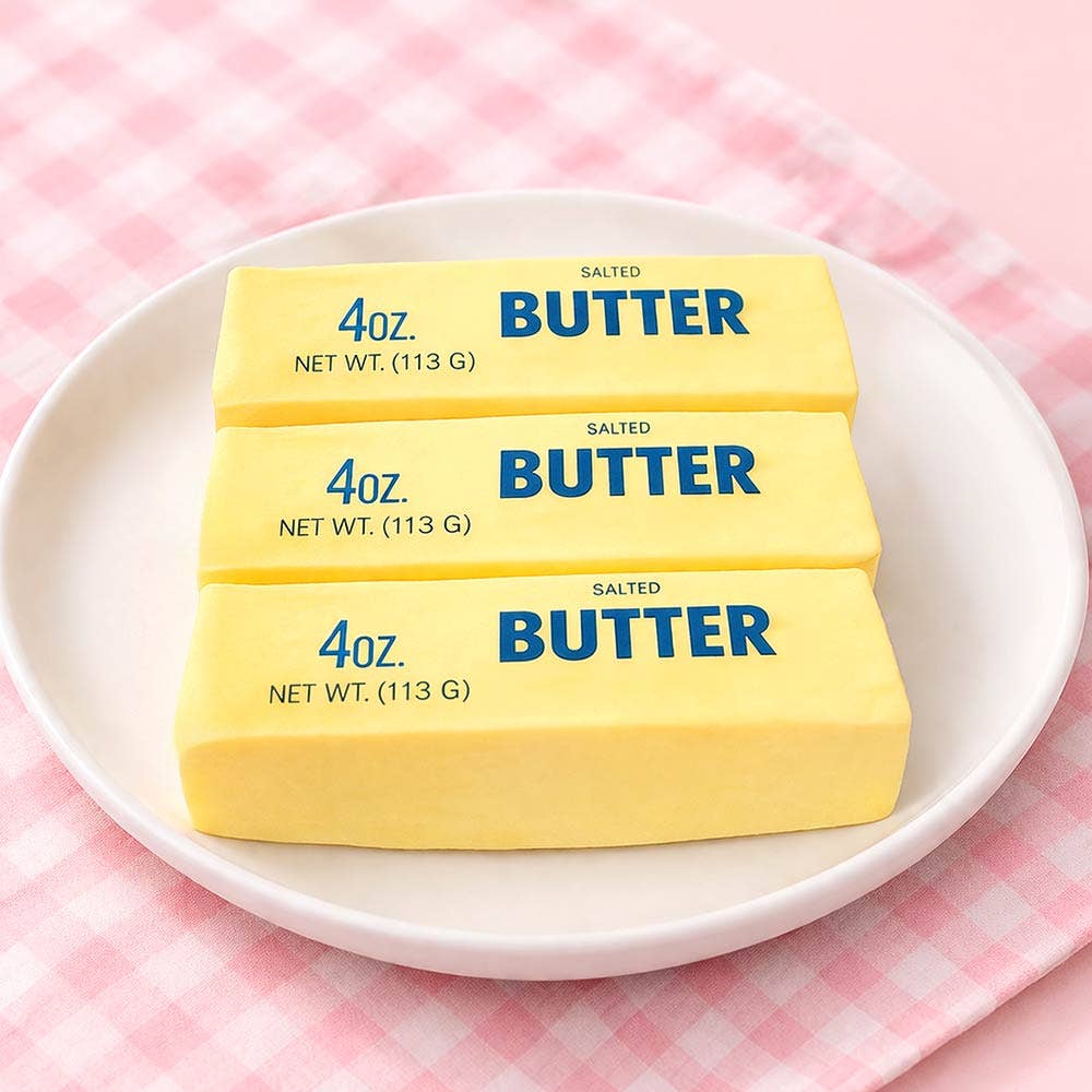 Box of 'Butter Mode' toy with yellow and blue design on a white background