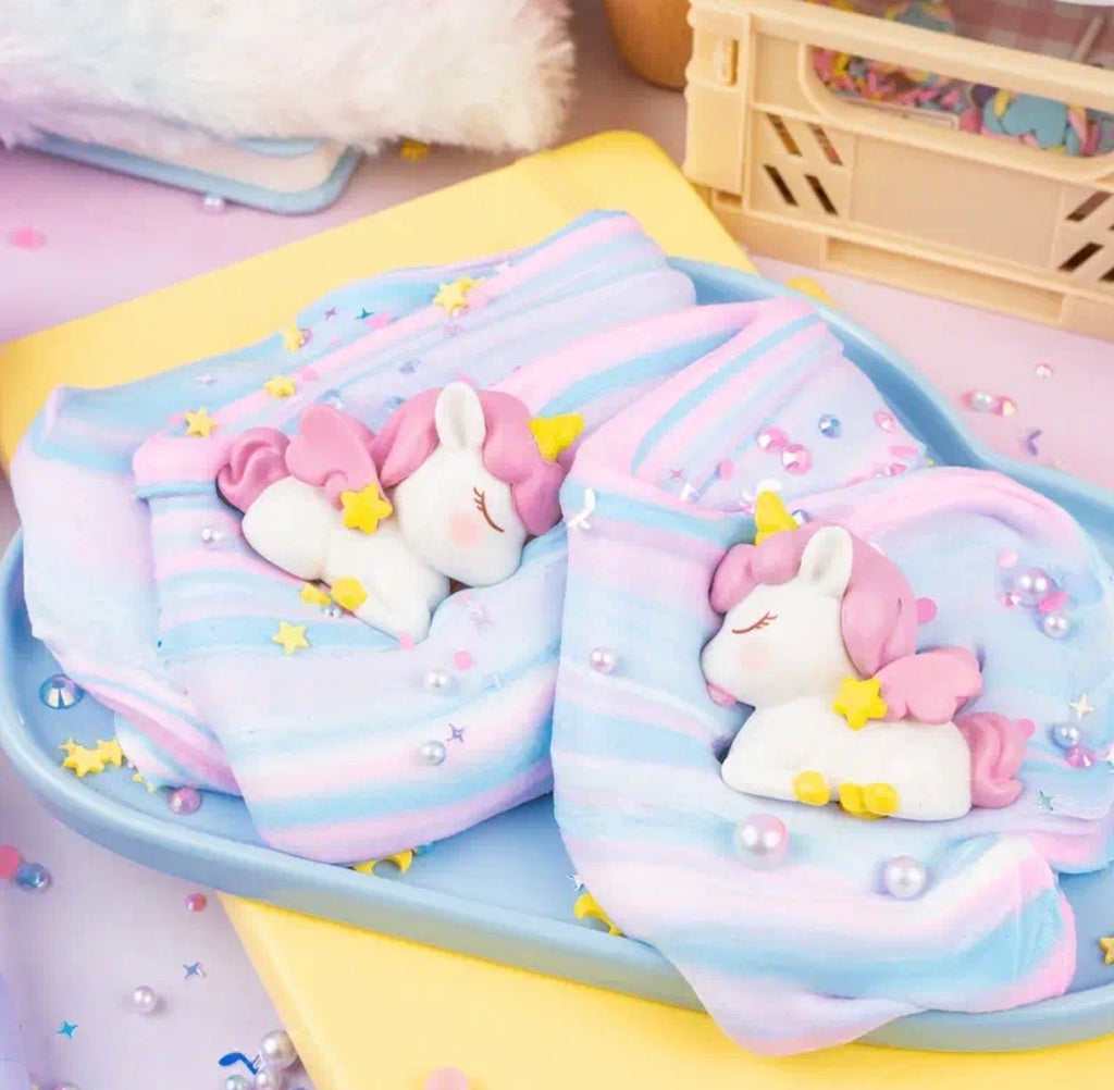 Unicorn toy with a blue bow inside a clear container on a white background