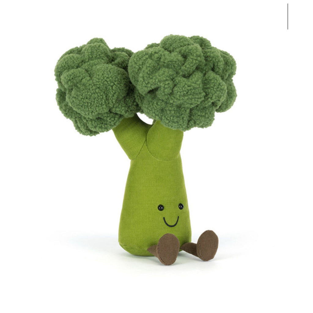 Plush toy shaped like broccoli with a smiling face on a white background