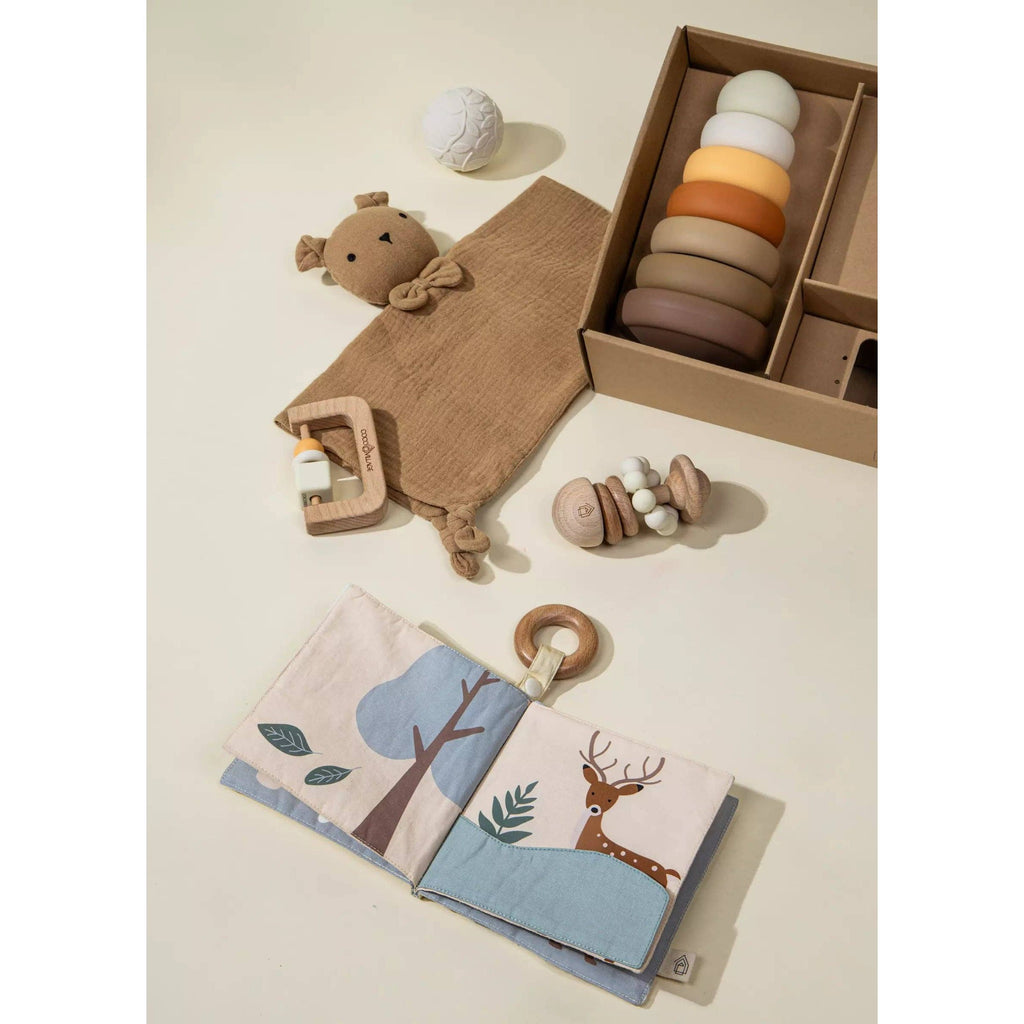 Baby product set with fox design in a box on a beige background