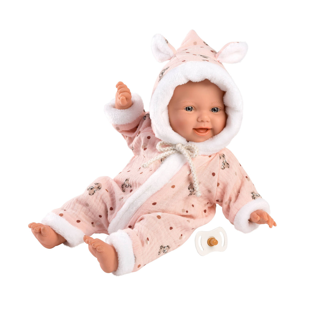 Baby doll wearing a pink onesie with white trim and bunny ears on a white background