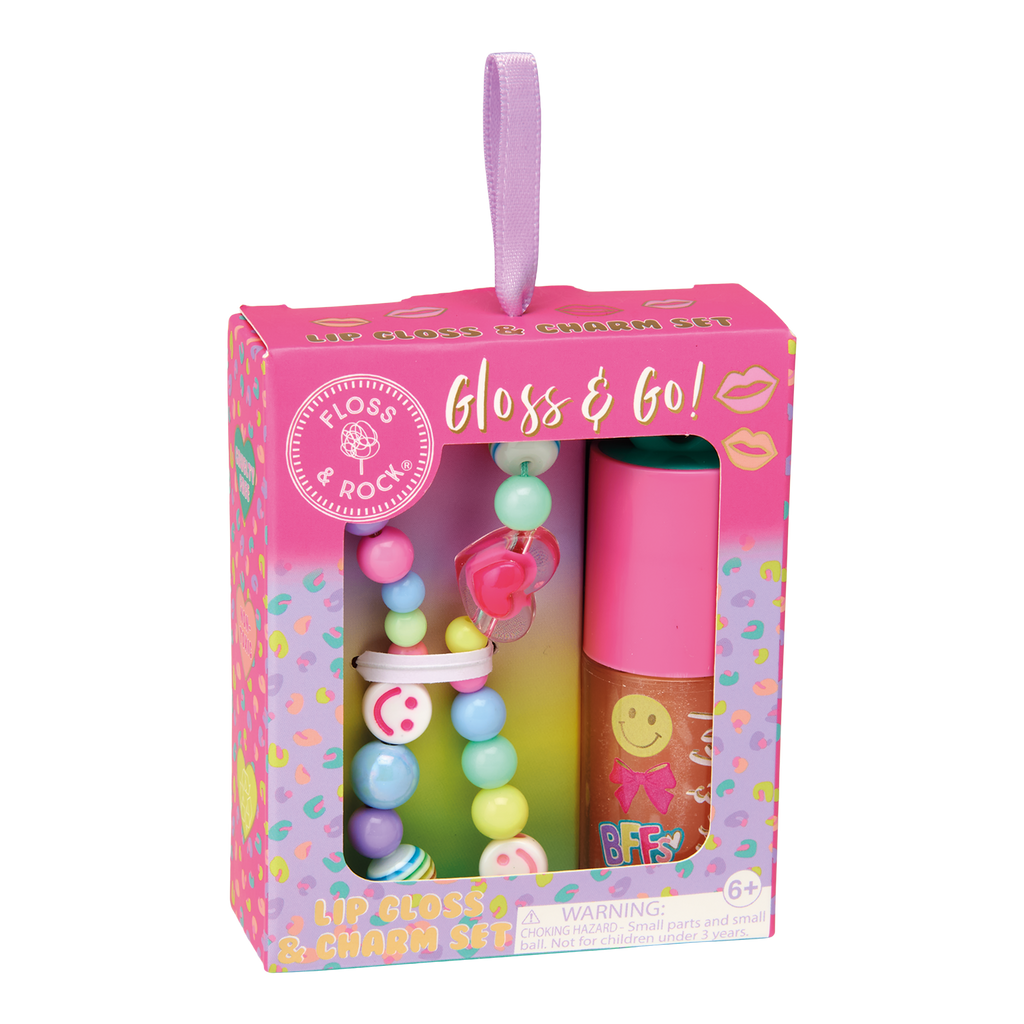 Display of 'Lip Gloss & Charm Set' packaging with pink and colorful design.