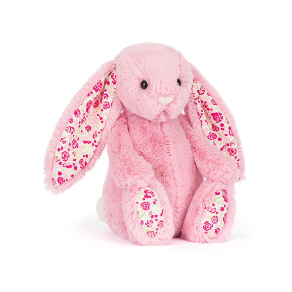 Pink plush bunny with floral patterns on a white background