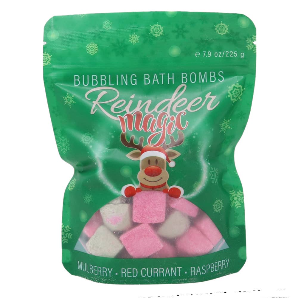 Green package of 'Reindeer Magic' bubbling bath bombs with bath bombs in front, Christmas tree in the background