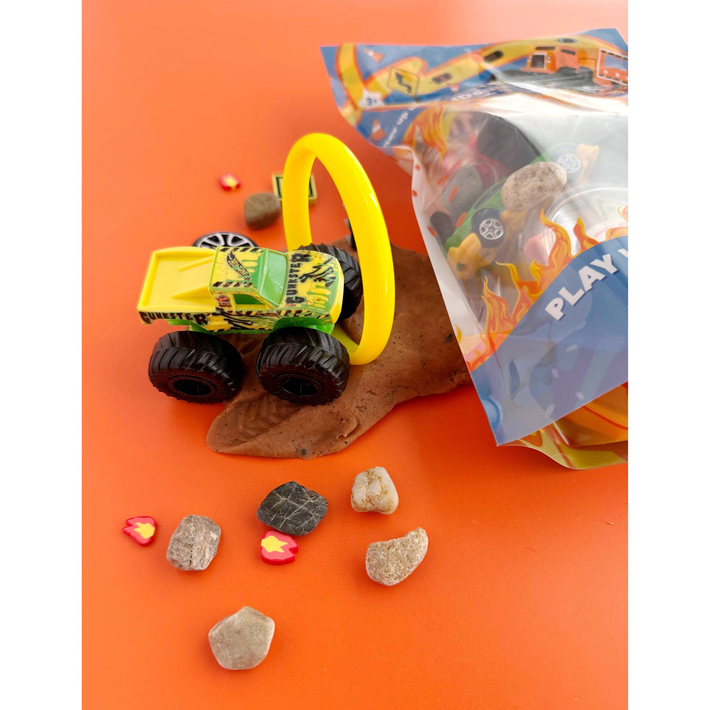 Monster Truck Kiddough Play Kit packaging on an orange background with toy trucks and accessories.