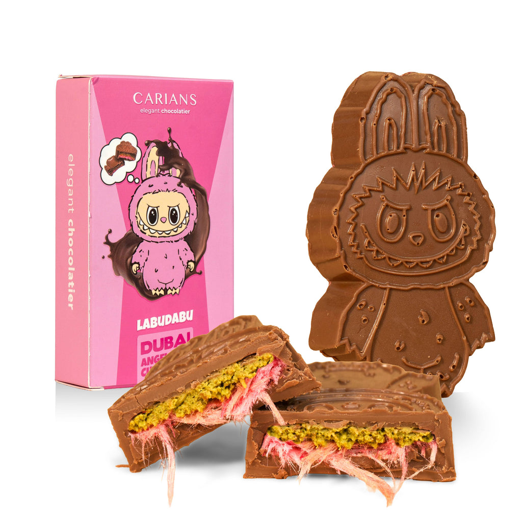 Chocolate cookie shaped like a character next to a pink Carians Labudabu packaging on a marble surface.
