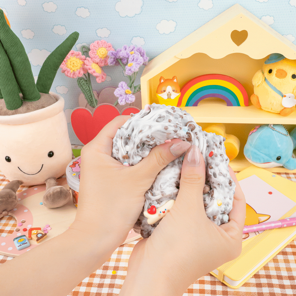 Get ready for a super pup-tastic Slime adventure with Cocoa Kibbles Crunchy Slime! This creamy white Slime is packed with crunchy kibbles that make the best snap, crackle, and pop just like your favorite cocoa cereal!  Plus, it smells so yummy and cozy, you’ll want to squish it all day long. Inside, you’ll find cute charms like a fluffy poodle, a bone, a fun dog house, and a tasty dog treat, all mixed with colorful sprinkle fimos for extra silly fun. With its crunchy texture and stretchy goodness, Cocoa