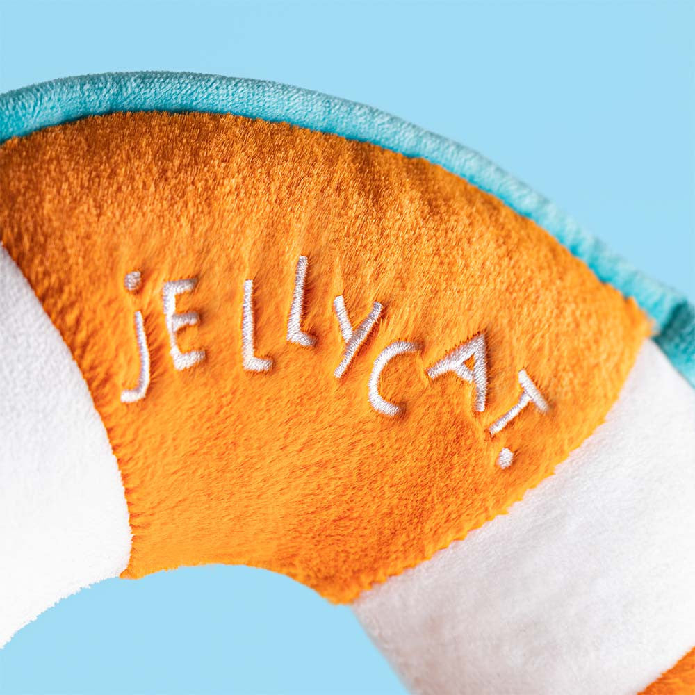 Plush toy life preserver with a smiling face on a white background, branded 'Jellycat'.