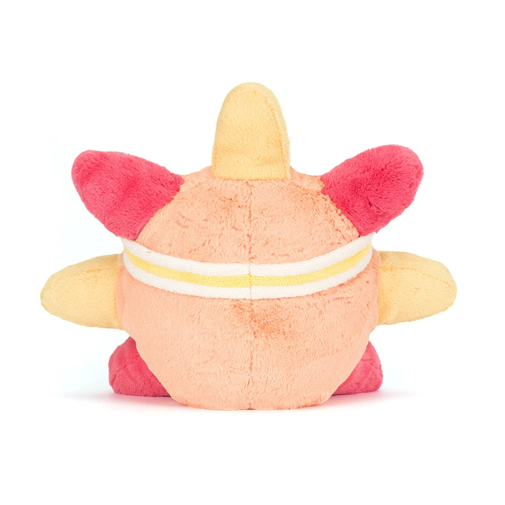 Plush toy with a star-shaped body and pink accents on a beige background