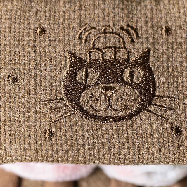 Plush toy resembling a s'more with marshmallows and chocolate on a white background