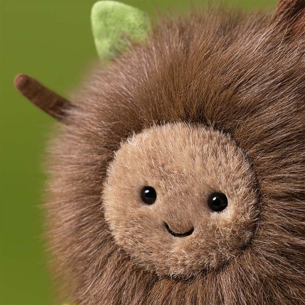 Plush toy hedgehog with a smiling face on a white background