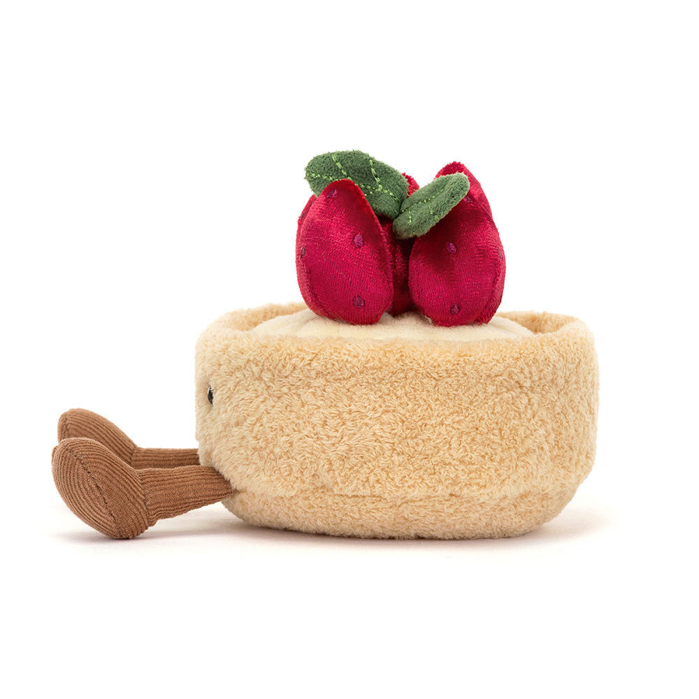 Jellycat Amuseables Fleurette Tarte Aux Fraises, a plush beige pastry with plush berries on top.