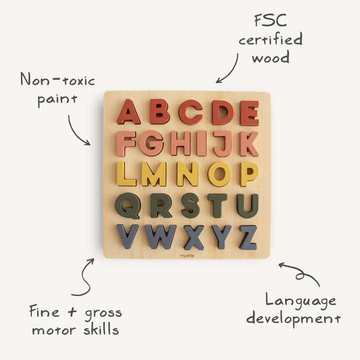 Wooden alphabet puzzle with colorful letters on a beige background