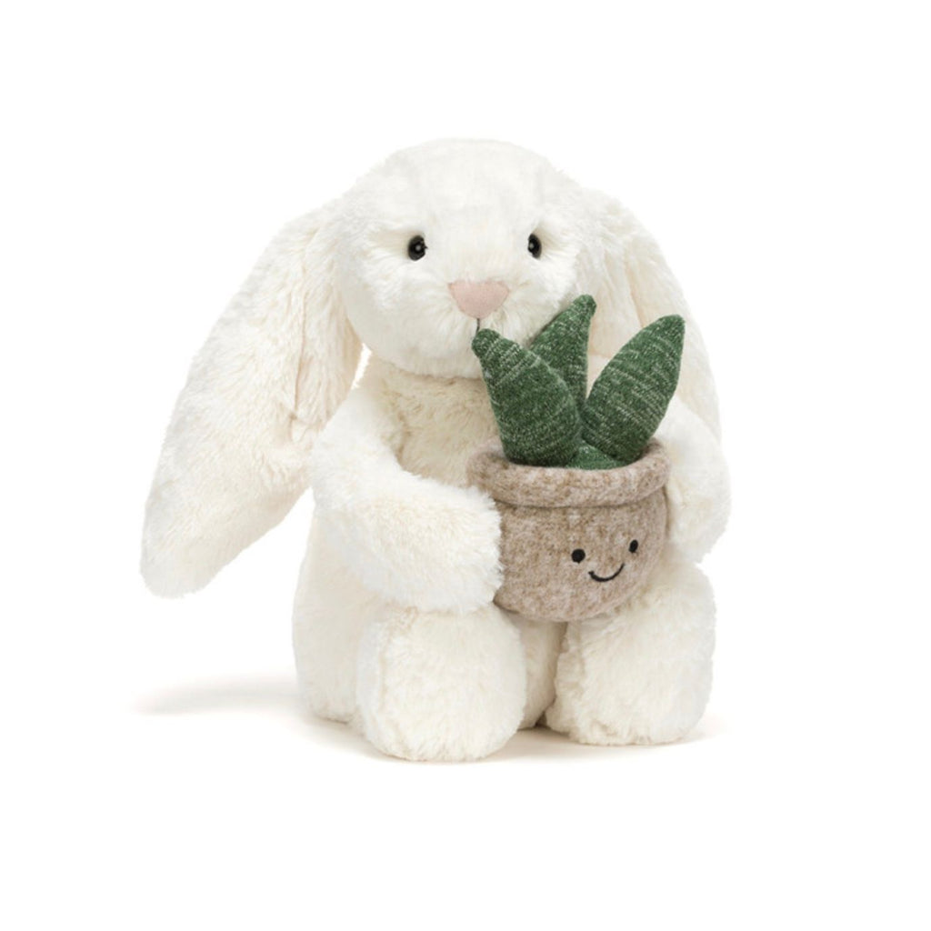 Stuffed bunny holding a potted plant on a white background