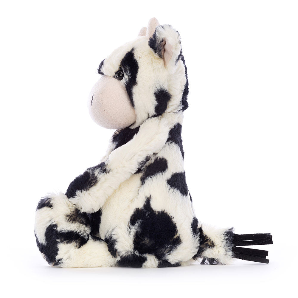 Plush cow toy with black and white pattern on a white background