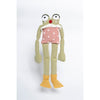 Crocheted frog toy with a pink polka dot shirt on a white background