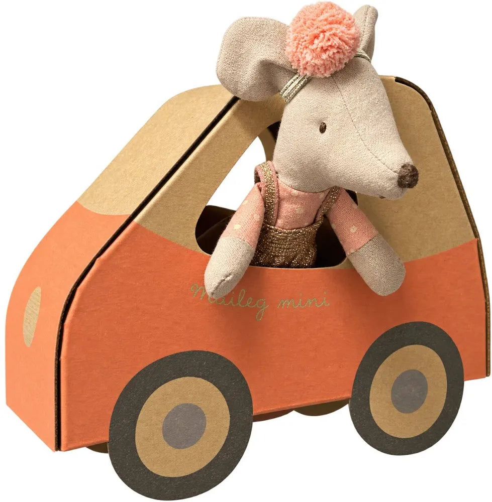 A plush toy mouse doll with beige fabric, wearing a pink and gold sequined dress with a pink pom-pom headband, set against a solid light beige background.