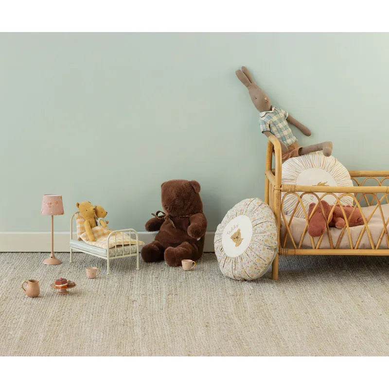 Brown teddy bear with a bow tie on a white background