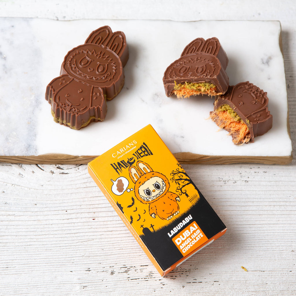 Chocolate bunny-shaped candies with a box labeled 'Lagunabu' on a white surface.