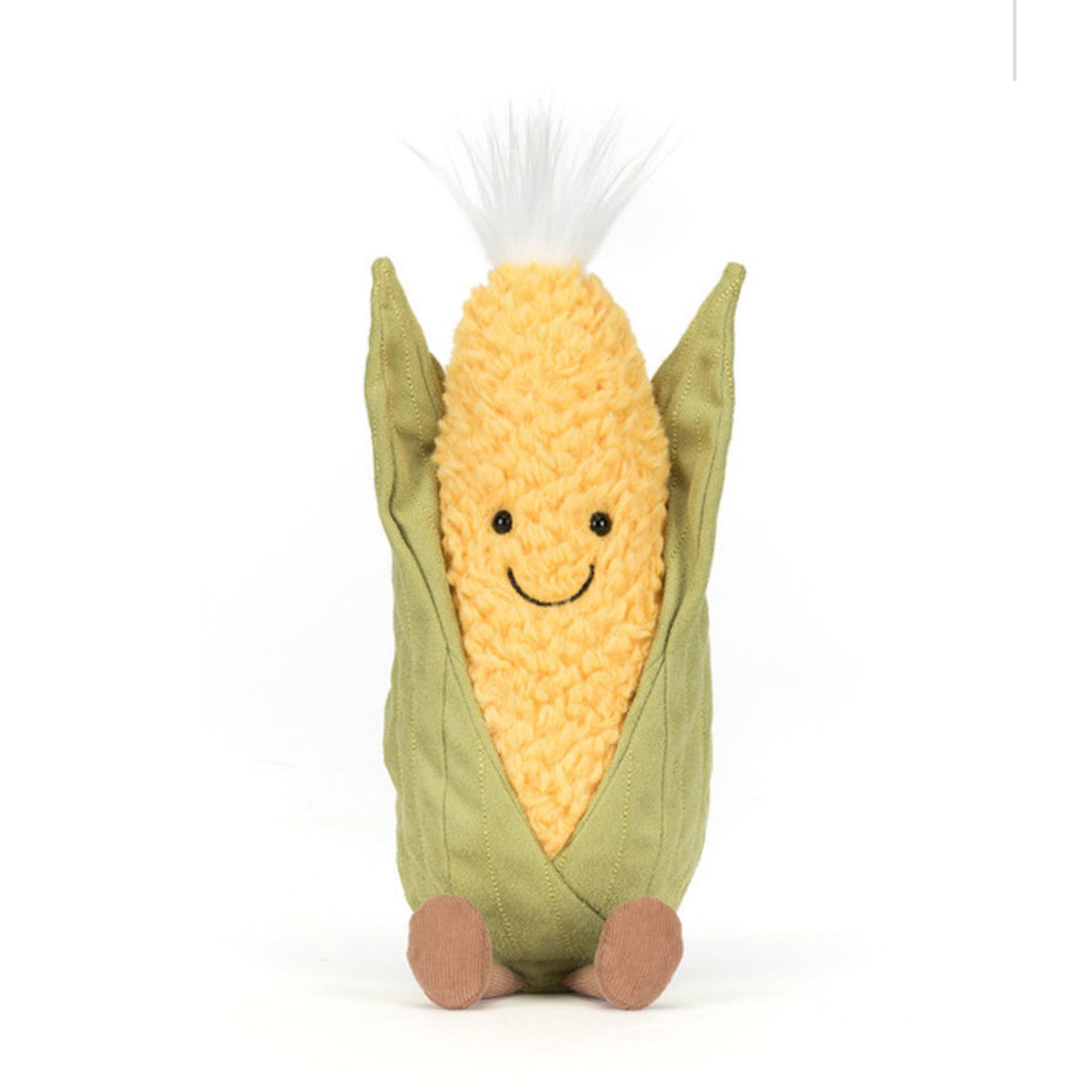 Plush toy corn on the cob with a smiling face on a white background