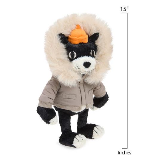 A plush toy dog wearing a beige parka with a large cream fur hood and black-and-white paws, photographed against a plain white background.