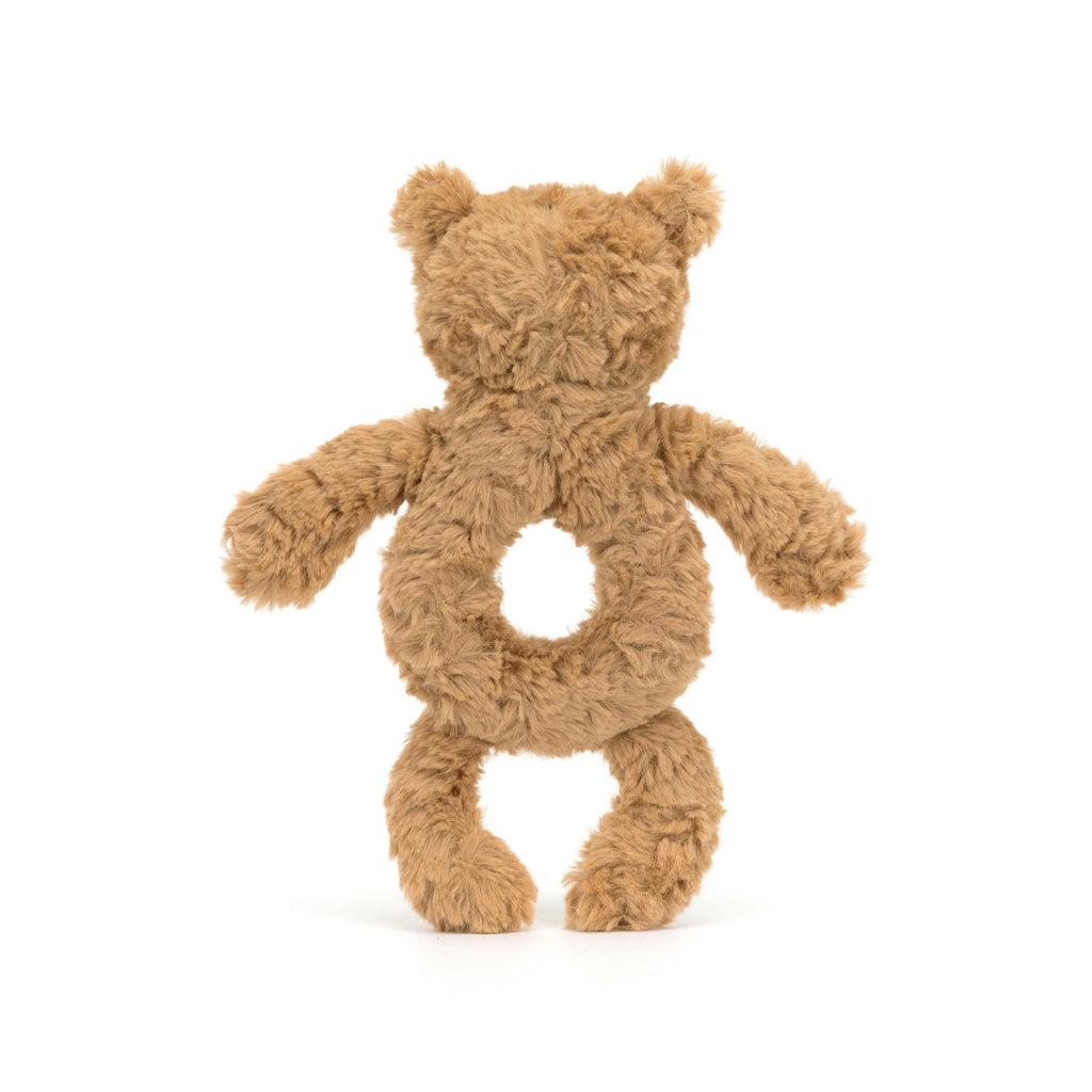 A plush teddy bear toy made from curly tan fabric, with a circular opening in the center of its torso, shown against a plain white background.