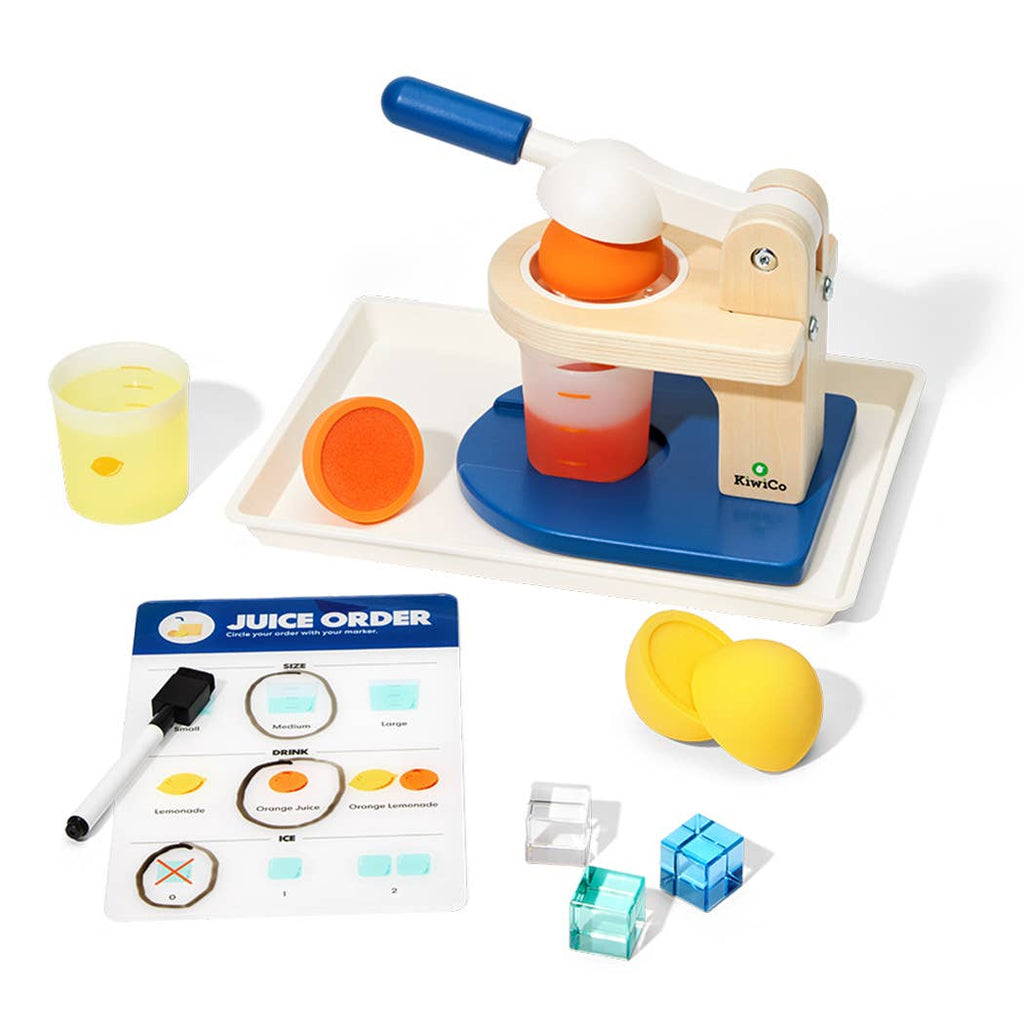 Children's wooden juice press set with oranges, cups, and a juice order chart on a wooden table.