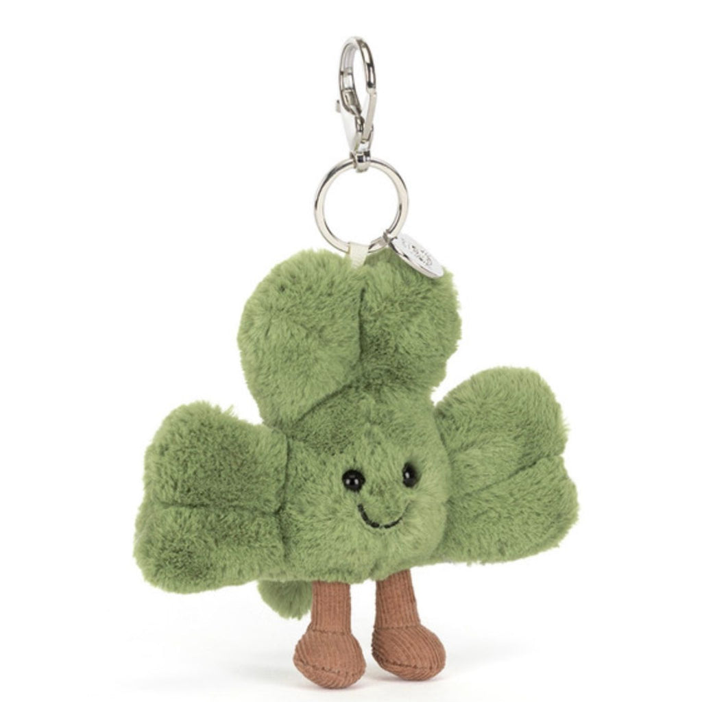 Green plush keychain with a smiling face on a white background