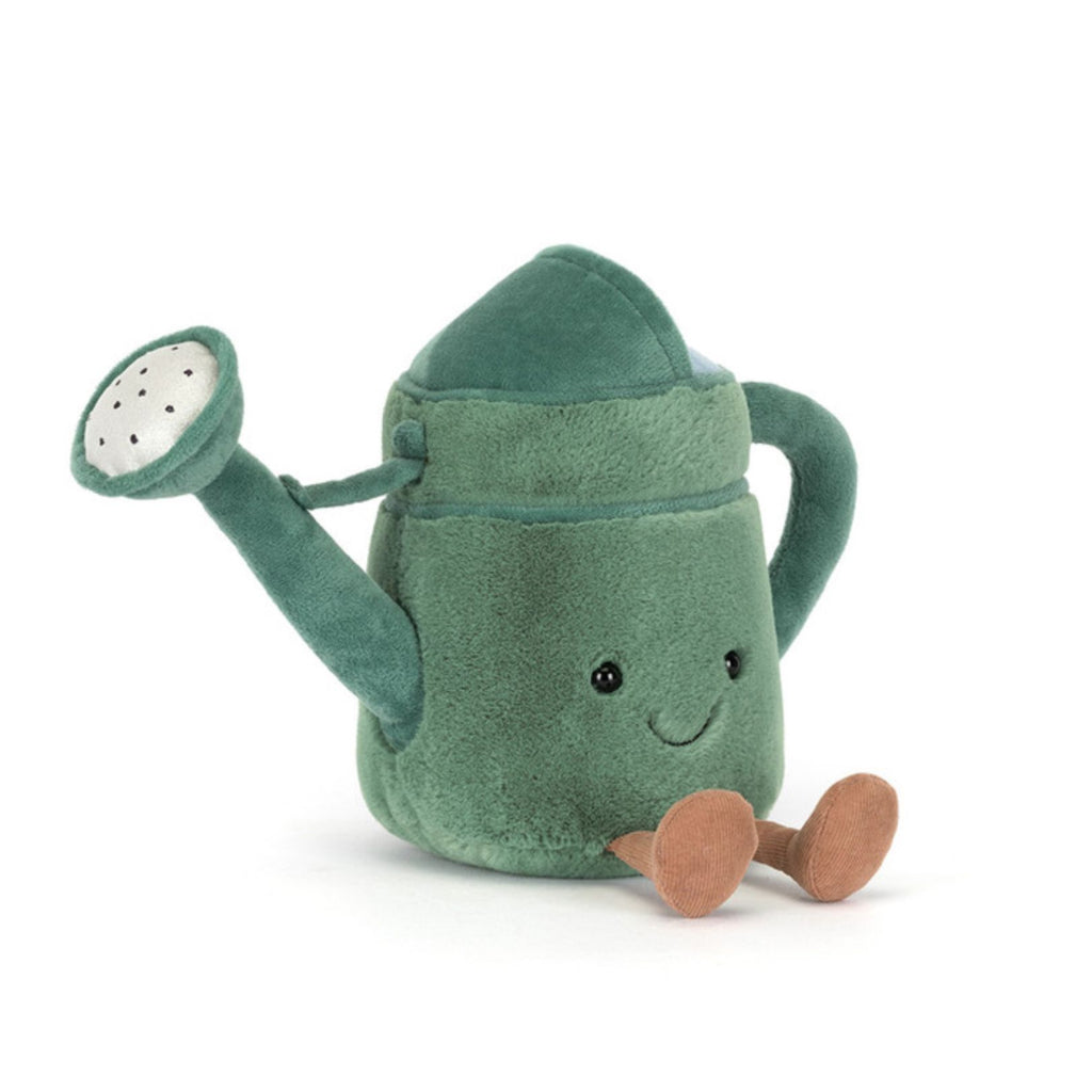 Green plush watering can toy with a smiling face on a white background
