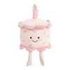 Plush toy resembling a birthday cake with a smiling face on a white background
