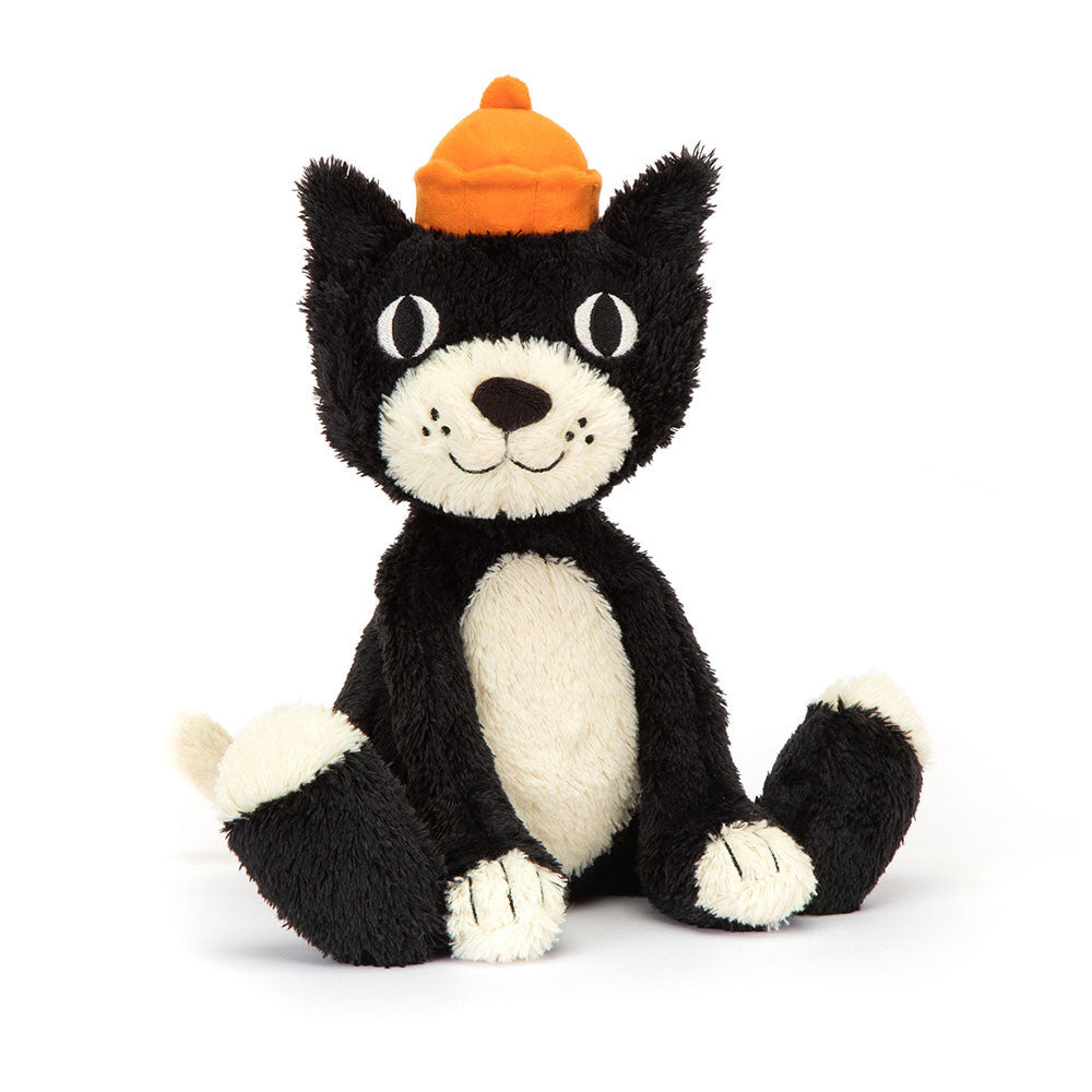 Black and white plush toy with a yellow hat on a blue background