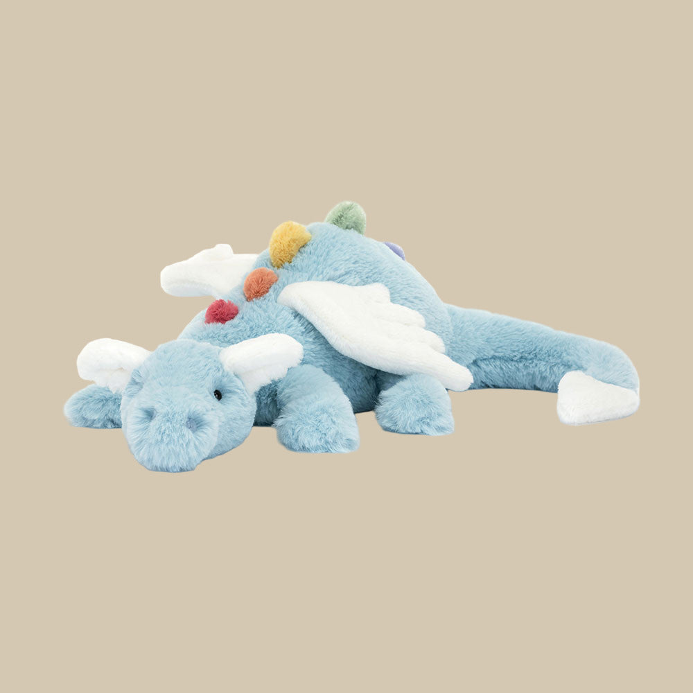  Jellycat Sky Dragon with blue fur, white wings, and rainbow spikes