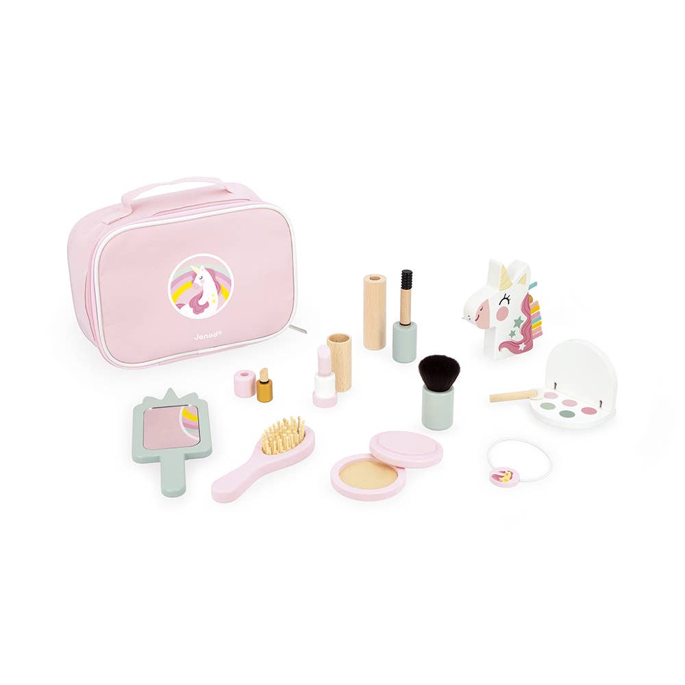 Pink makeup set with various tools including a mirror and brushes on a white background